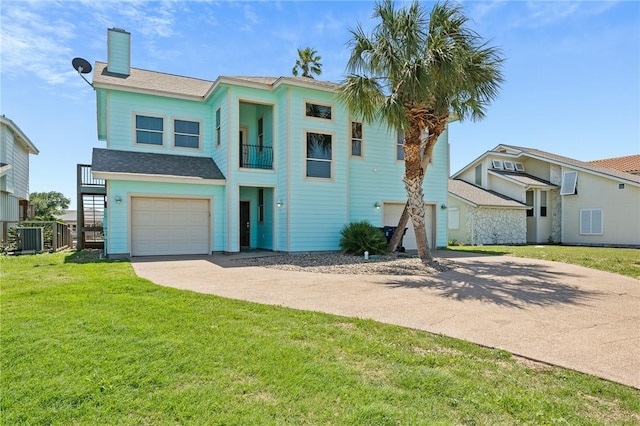 227 Windjammer St, Rockport, TX 78382 - view of front facade featuring concrete driveway, a garage, a chimney, a front yard, and a balcony
