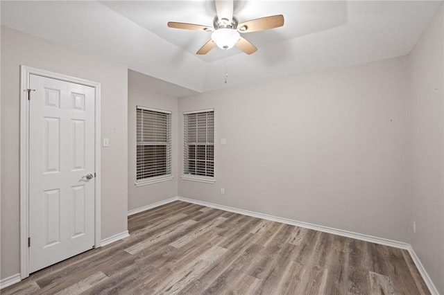 empty room featuring ceiling fan and light hardwood / wood-style flooring