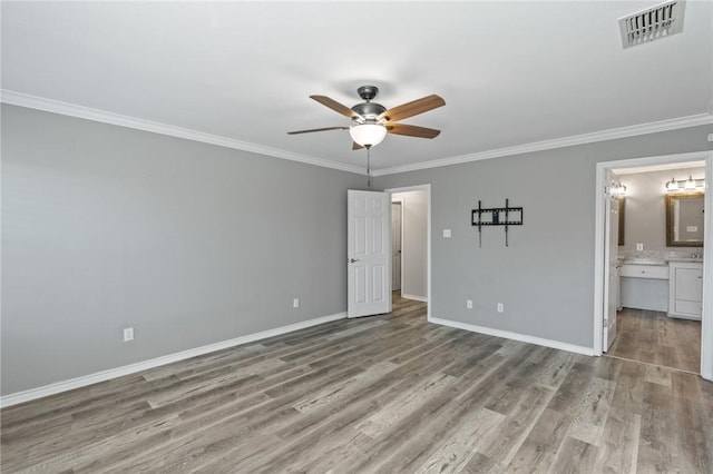 unfurnished bedroom with ceiling fan, ornamental molding, light hardwood / wood-style flooring, and ensuite bath