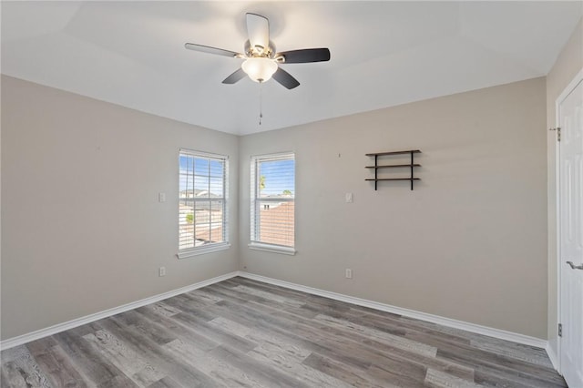 unfurnished room featuring hardwood / wood-style floors and ceiling fan