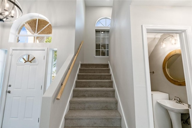 stairway featuring sink and carpet