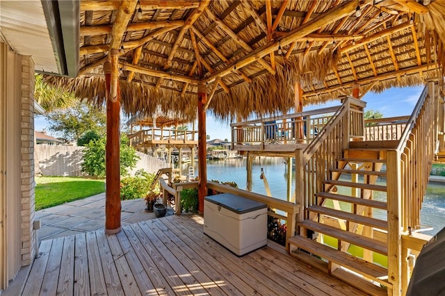 dock area featuring a gazebo and a deck with water view