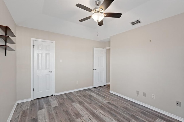 unfurnished bedroom featuring hardwood / wood-style flooring and ceiling fan