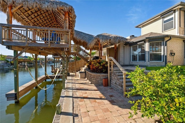 13845 Jolly Roger St, Corpus Christi, TX 78418 - dock featuring boat lift, stairway, and a deck with water view