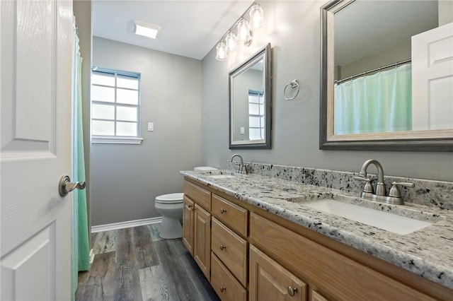 bathroom featuring hardwood / wood-style floors, vanity, and toilet