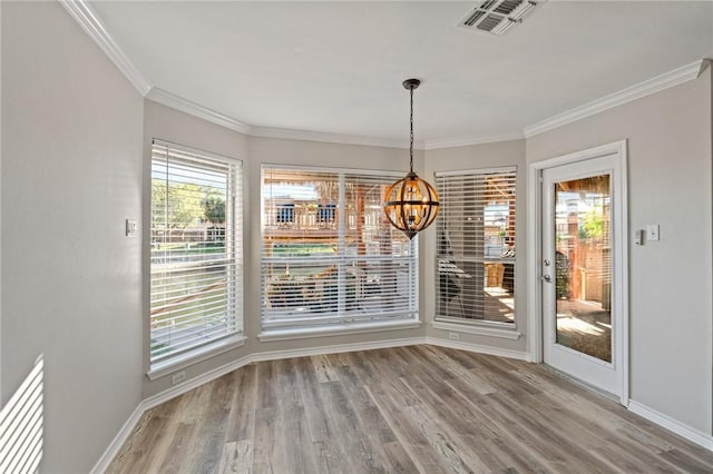13845 Jolly Roger St, Corpus Christi, TX 78418 - unfurnished dining area with a chandelier, wood finished floors, baseboards, and ornamental molding