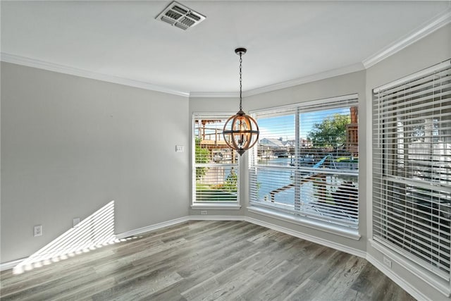13845 Jolly Roger St, Corpus Christi, TX 78418 - unfurnished dining area featuring a chandelier, wood finished floors, crown molding, and baseboards