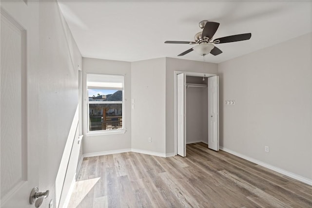 unfurnished bedroom with a closet, ceiling fan, and light hardwood / wood-style flooring