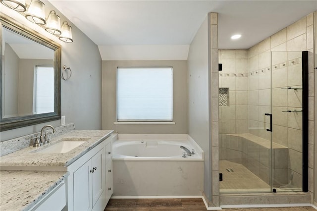 13845 Jolly Roger St, Corpus Christi, TX 78418 - bathroom featuring vanity, a garden tub, a stall shower, wood finished floors, and healthy amount of natural light