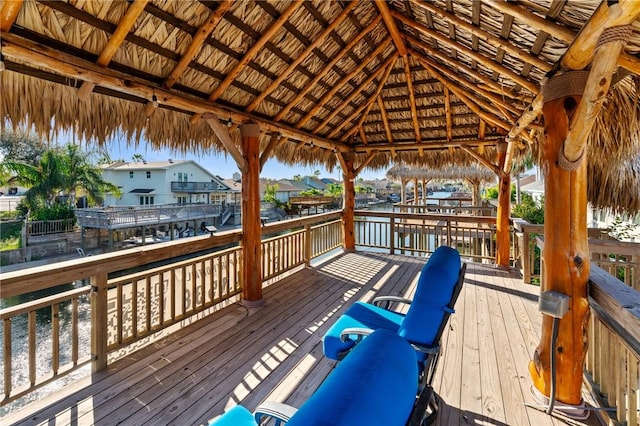 wooden deck with a gazebo and a water view