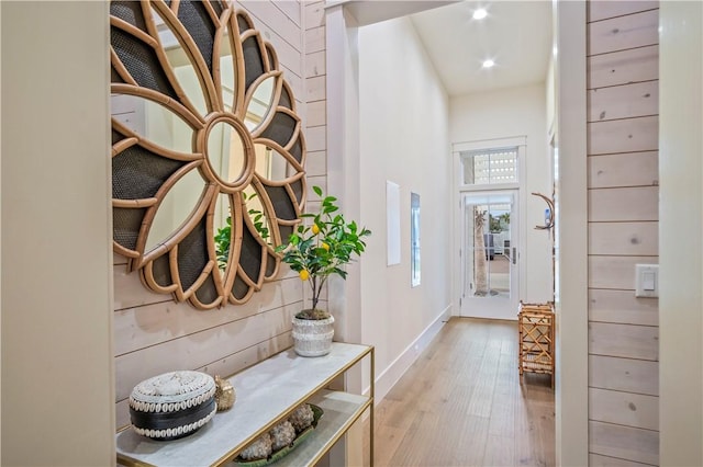 interior space featuring a high ceiling and light hardwood / wood-style floors