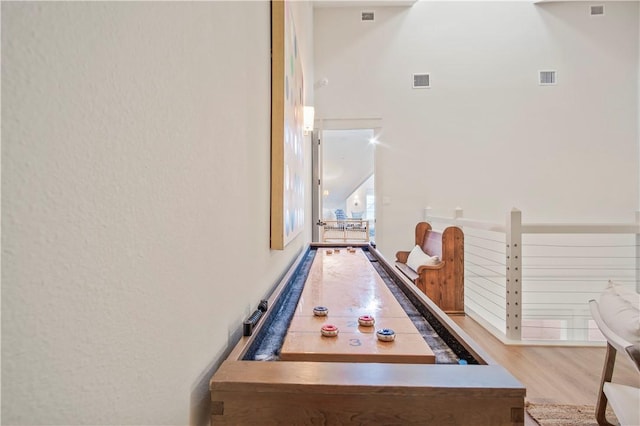 game room with light hardwood / wood-style flooring