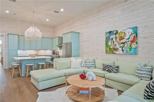 living room featuring an inviting chandelier and light hardwood / wood-style floors