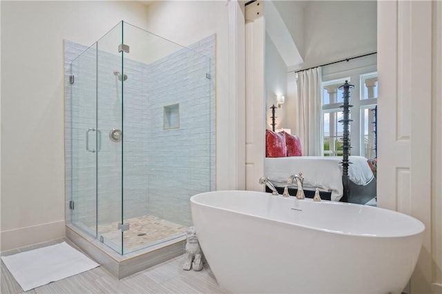 bathroom with separate shower and tub