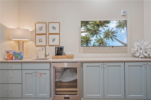 bar featuring sink and beverage cooler