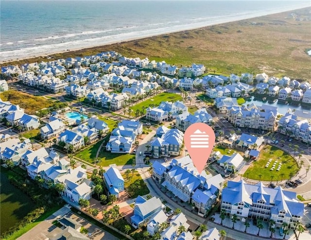 birds eye view of property featuring a view of the beach and a water view