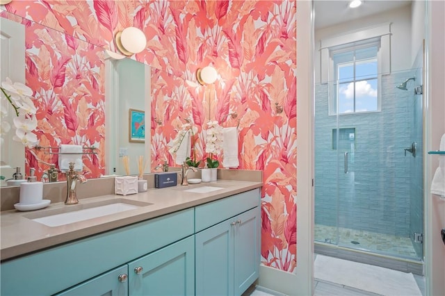 bathroom featuring a shower with door and vanity