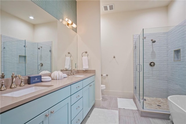 full bathroom featuring vanity, toilet, and separate shower and tub