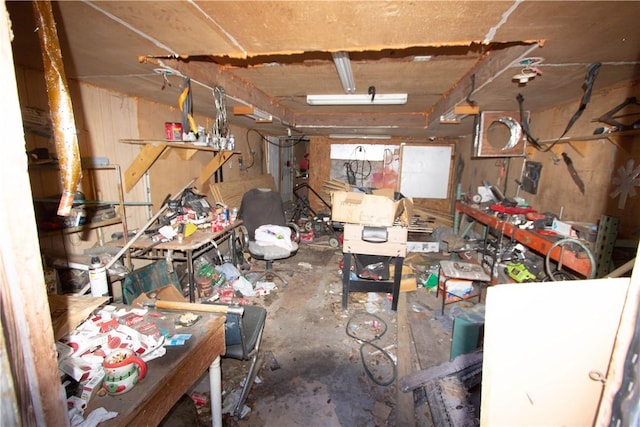 misc room featuring concrete flooring and a workshop area