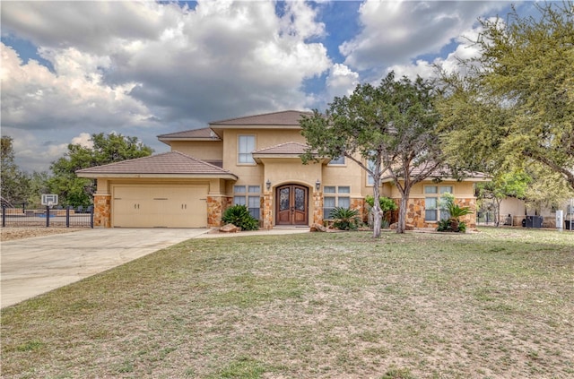 view of front of property featuring a garage and a front lawn