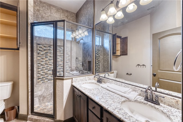 bathroom with toilet, vanity, and an enclosed shower