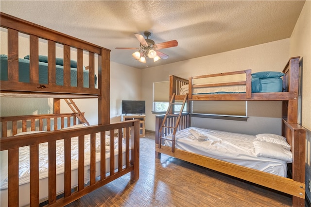 bedroom with a textured ceiling, hardwood / wood-style flooring, and ceiling fan