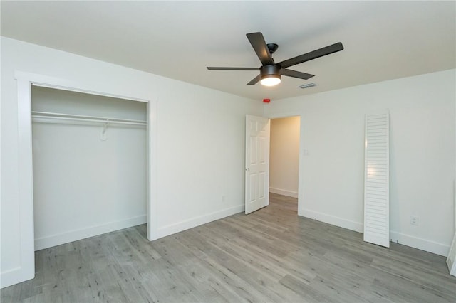 unfurnished bedroom with ceiling fan and light wood-type flooring