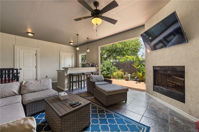 15229 Capstan St, Corpus Christi, TX 78418 - living room featuring exterior fireplace, ceiling fan, and tile patterned flooring