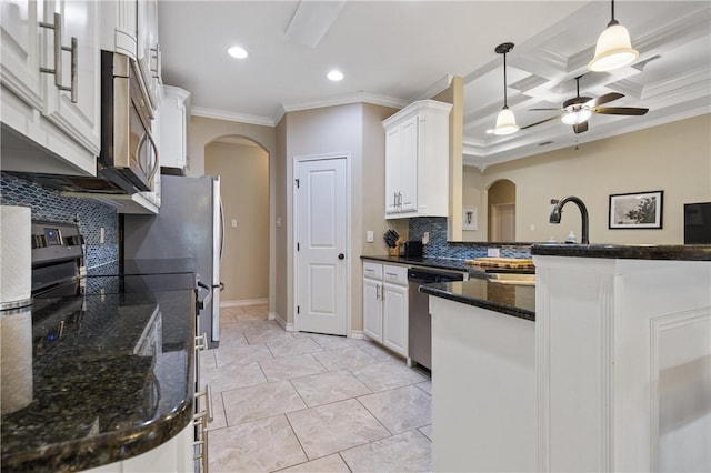 15229 Capstan St, Corpus Christi, TX 78418 - kitchen featuring arched walkways, appliances with stainless steel finishes, ornamental molding, a ceiling fan, and decorative backsplash