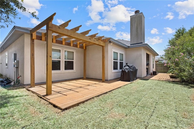 15229 Capstan St, Corpus Christi, TX 78418 - back of house with a wooden deck, stucco siding, a chimney, and a pergola
