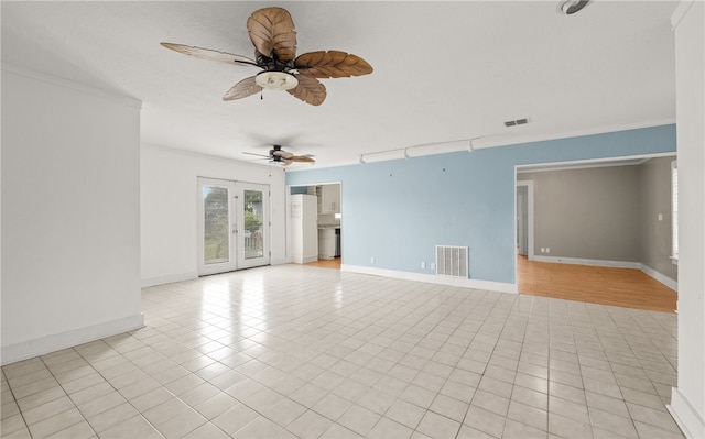 empty room with ornamental molding, light tile patterned floors, and ceiling fan