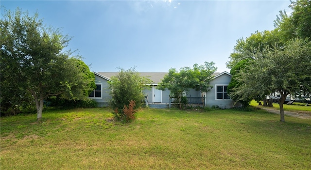 back of property featuring a lawn