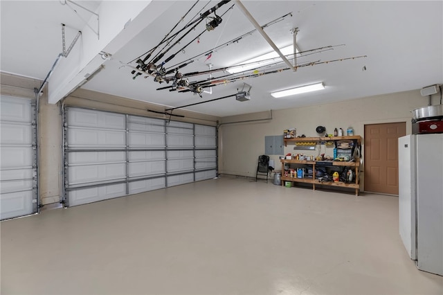 garage with a garage door opener and white refrigerator