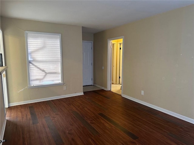 spare room with dark wood-type flooring