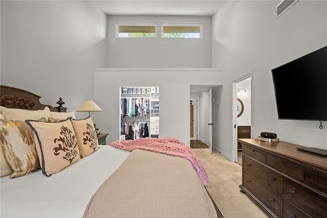 5418 Stonegate Way, Corpus Christi, TX 78411 - bedroom featuring light carpet, a high ceiling, a spacious closet, and ensuite bath