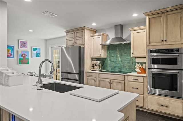 5418 Stonegate Way, Corpus Christi, TX 78411 - kitchen featuring stainless steel appliances, wall chimney exhaust hood, light brown cabinetry, light countertops, and recessed lighting