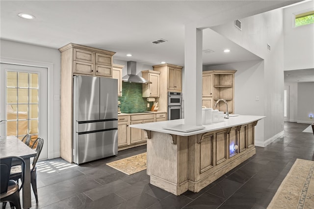 5418 Stonegate Way, Corpus Christi, TX 78411 - kitchen with appliances with stainless steel finishes, wall chimney exhaust hood, light brown cabinets, light countertops, and recessed lighting