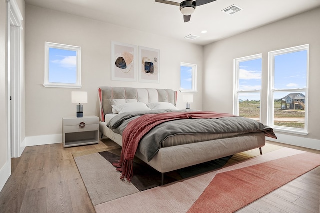 bedroom with light wood-type flooring and ceiling fan