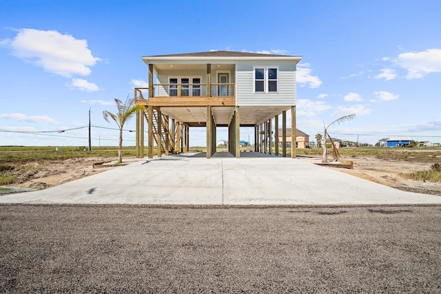 coastal inspired home featuring a porch and a carport