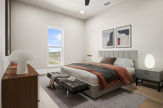 bedroom with ceiling fan and wood-type flooring