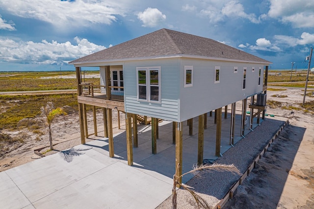 back of house featuring a carport