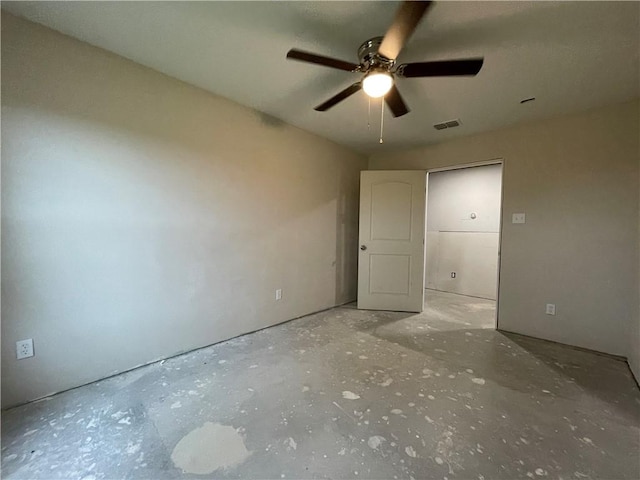 spare room featuring ceiling fan and concrete flooring