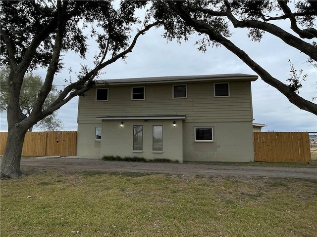 rear view of house with a yard