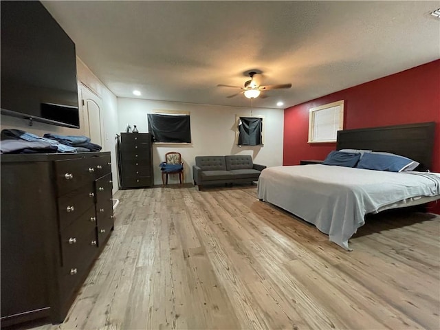 bedroom with ceiling fan and light hardwood / wood-style floors