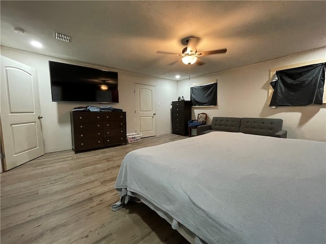 bedroom with ceiling fan and light wood-type flooring