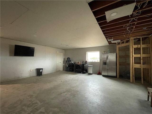 basement with stainless steel fridge