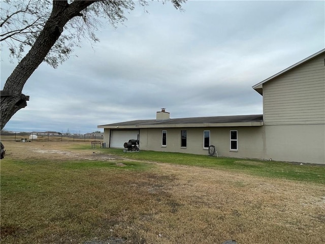 rear view of property with a yard