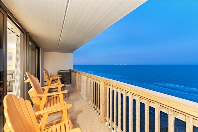 balcony with a view of the beach and a water view