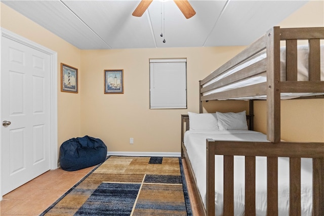 tiled bedroom featuring ceiling fan