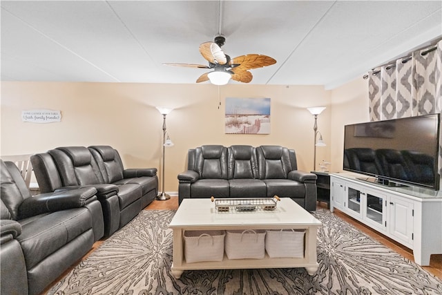 living room with ceiling fan and light hardwood / wood-style flooring